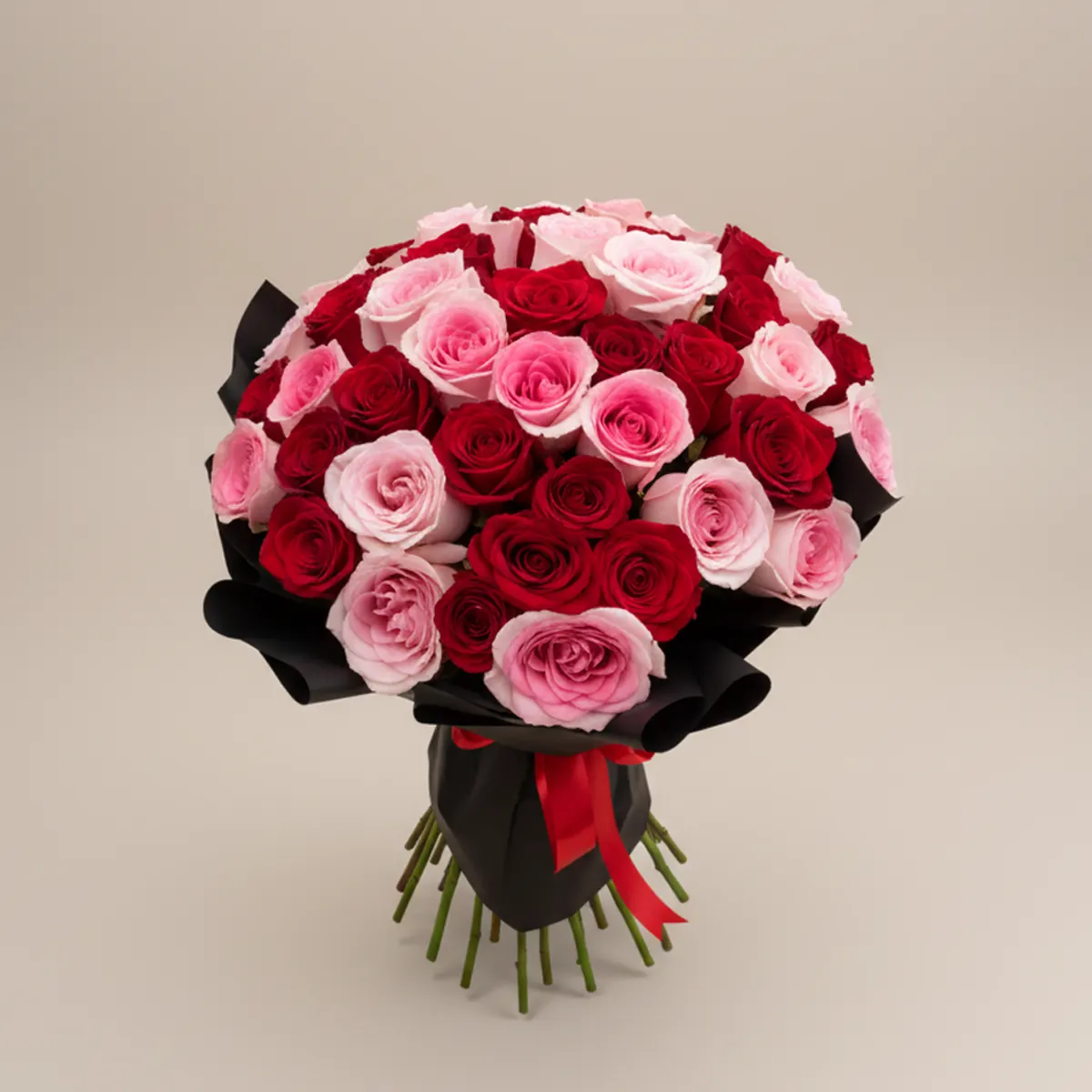 51 red and pink roses in black wrapping with a red ribbon